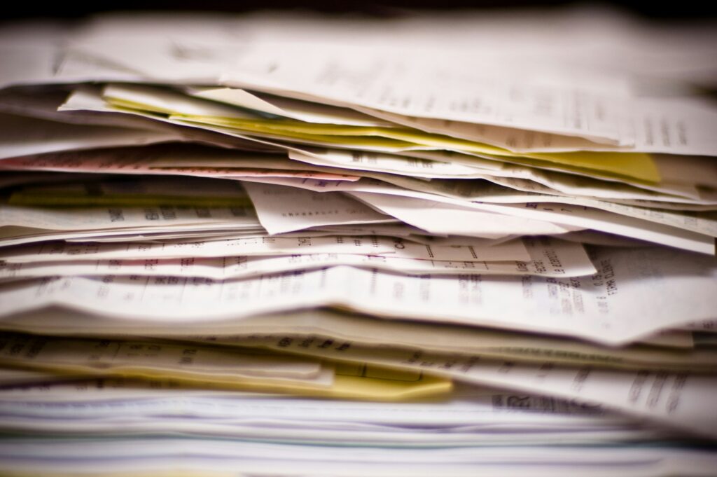A stack of loose paperwork and receipts