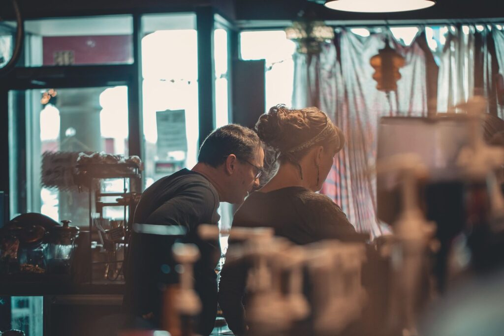 Two small business owners talking in a cafe