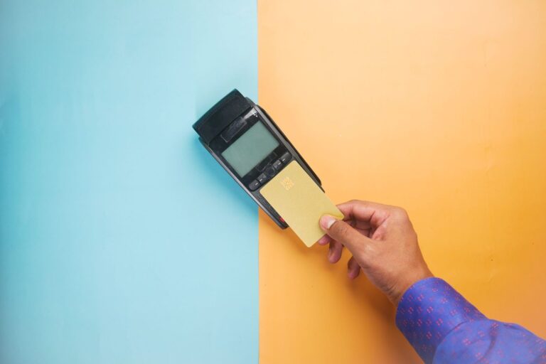 Card being held to a handheld card payment reader